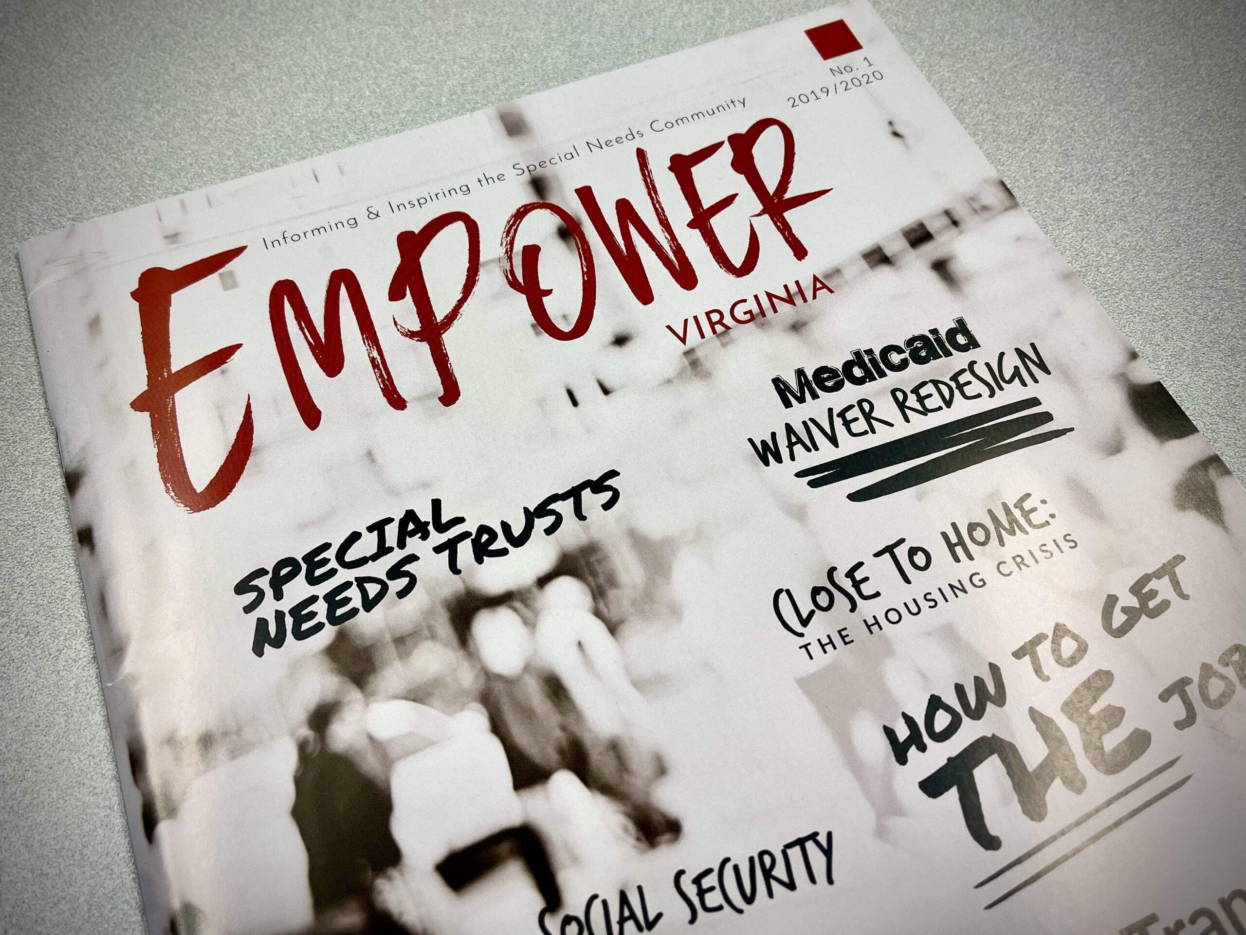 A copy of The Arc of Northern Virginia's Empower magazine sits on an off-white desk top.