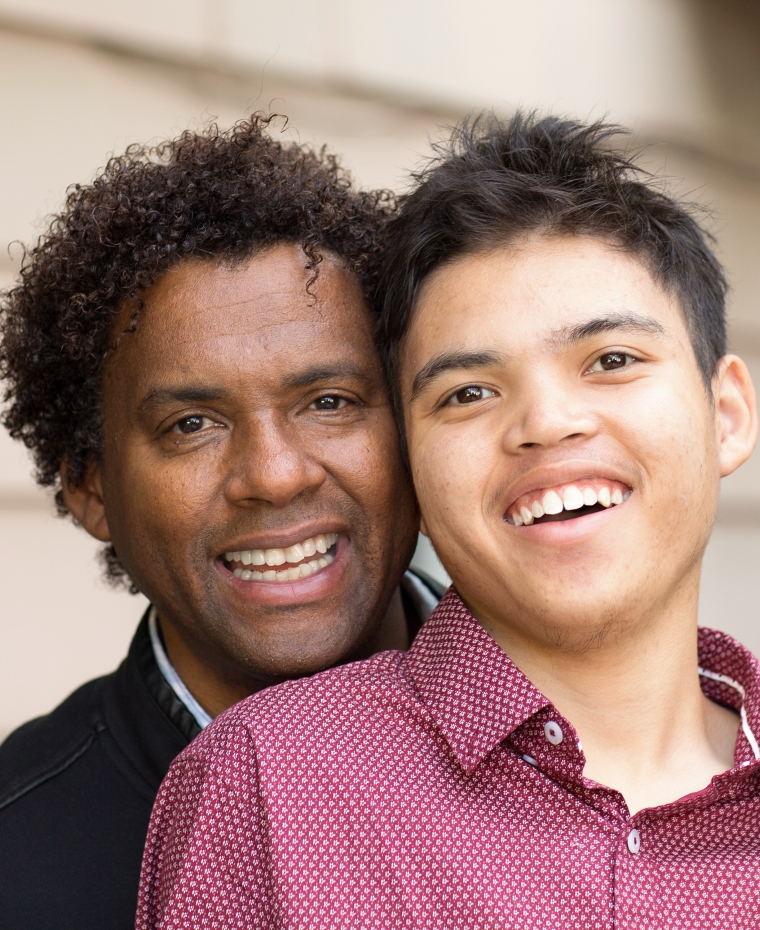 close-up photo of a father and son smiling