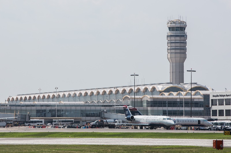 photo view of Reagan national airport from the runway, with a jet plane in front of the terminal