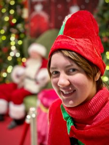 photo of Schuyler Hudson smiling wearing a red elf hat